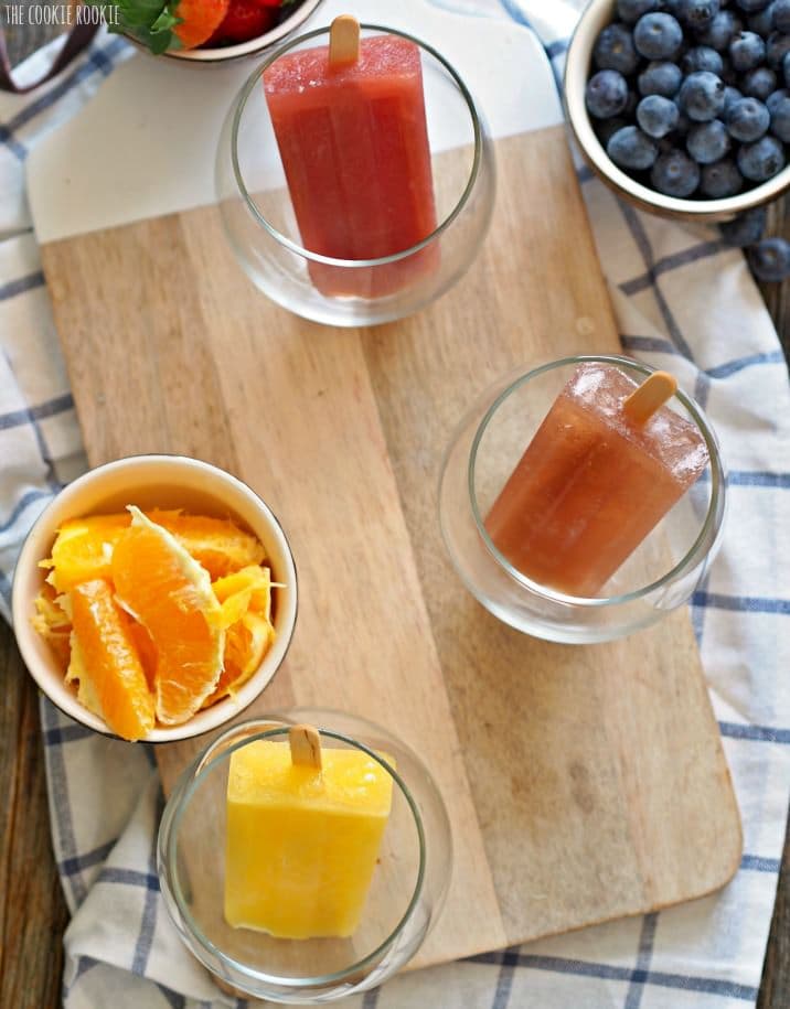 Mimosa Popsicles in Orange, Strawberry, Apple Cider, Blueberry, and Pineapple! So fun and delicious. Mimosa Champagne Pops for adults!