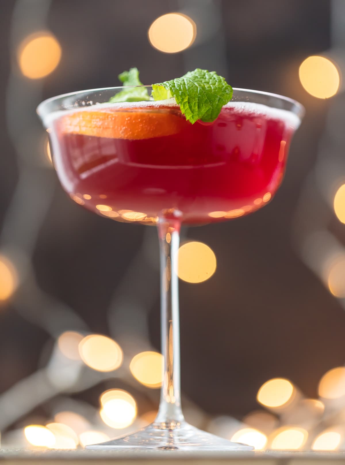 This SPARKLING HOLIDAY FLIRTINI is fun, pretty, and delicious! Cranberry and pineapple juice mixed with orange vodka and topped with red moscato champagne, what could be better or more festive for Christmas or New Years Eve!