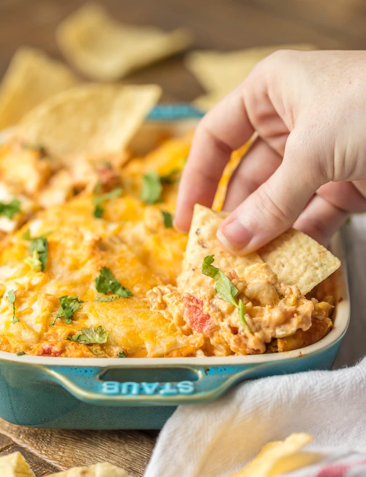 KING RANCH CHICKEN DIP is a fun twist on a classic family favorite casserole. The flavors including chicken, rotel, cheese, and tortillas lend themselves easily to a delicious dip, just perfect for the Super Bowl!